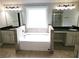 Bathroom featuring double vanity, soaking tub, and a tiled shower at 232 Clubhouse Xing, Acworth, GA 30101