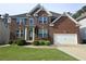 Beautiful two-story brick home with a well-manicured lawn and two car garage at 232 Clubhouse Xing, Acworth, GA 30101