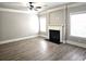 Cozy living room with a fireplace, large windows, and hard surface floors at 232 Clubhouse Xing, Acworth, GA 30101