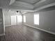 Main bedroom featuring tray ceilings, ceiling fan, and hardwood floors at 232 Clubhouse Xing, Acworth, GA 30101