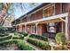 Charming brick home featuring a manicured backyard, an iron gate, and inviting outdoor seating areas at 3456 Paces Nw Pl, Atlanta, GA 30327