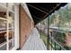 Long balcony with black iron railing overlooking manicured hedges and trees at 3456 Paces Nw Pl, Atlanta, GA 30327