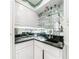 Elegant bar area with mirrored backsplash, glass shelves, and granite countertop at 3456 Paces Nw Pl, Atlanta, GA 30327