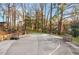 Outdoor basketball court complete with hoop, benches, and ample playing space surrounded by lush trees at 3456 Paces Nw Pl, Atlanta, GA 30327