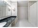 Traditional bathroom with marble counters, patterned wallpaper, and a shower with white tile at 3456 Paces Nw Pl, Atlanta, GA 30327