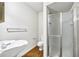 Bathroom features wood floors, white sink and a glass shower at 3456 Paces Nw Pl, Atlanta, GA 30327