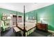 Bright bedroom features green walls, four-poster bed, sitting chair and access to outside patio at 3456 Paces Nw Pl, Atlanta, GA 30327