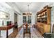 Classic dining room with chandelier, built-in hutch, and French doors providing backyard views at 3456 Paces Nw Pl, Atlanta, GA 30327