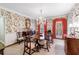 Formal dining room featuring a large wooden table, floral wallpaper, and natural light from shuttered windows at 3456 Paces Nw Pl, Atlanta, GA 30327