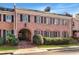 Brick townhome with elegant architecture, a covered entry, and manicured landscaping at 3456 Paces Nw Pl, Atlanta, GA 30327