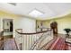 Upstairs landing with a skylight, hardwood floors, and elegant architectural details at 3456 Paces Nw Pl, Atlanta, GA 30327