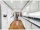 Bright kitchen featuring sleek white cabinetry, granite counters, and modern appliances at 3456 Paces Nw Pl, Atlanta, GA 30327