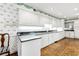 Bright kitchen features sleek white cabinetry, black granite countertops, and hardwood floors, perfect for cooking at 3456 Paces Nw Pl, Atlanta, GA 30327