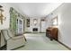 Cozy living room with a fireplace, built-in bookshelves, and access to the outdoors at 3456 Paces Nw Pl, Atlanta, GA 30327
