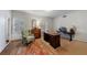 Bright home office with wooden desk, oriental rug, shutters on windows, and a neutral color scheme at 3456 Paces Nw Pl, Atlanta, GA 30327