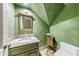 Unique powder room with decorative green walls, marble countertop, and vintage accents at 3456 Paces Nw Pl, Atlanta, GA 30327