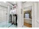 Walk-in closet leading into a bedroom, showcasing closet organization and neutral patterned wallpaper at 3456 Paces Nw Pl, Atlanta, GA 30327