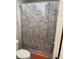 Bathroom with toilet and shower featuring a city scape shower curtain at 457 Panhandle Pl, Hampton, GA 30228