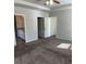 This carpeted bedroom features a fan, en suite bathroom, and closet, blending comfort and convenience at 457 Panhandle Pl, Hampton, GA 30228
