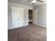 Bedroom with ceiling fan, carpeting, and closet with white double doors at 457 Panhandle Pl, Hampton, GA 30228