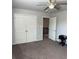 Bedroom with double closet, open entry to the upper level, ceiling fan, and carpeted floor at 457 Panhandle Pl, Hampton, GA 30228