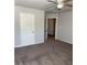 Bedroom with carpet, ceiling fan, bright windows and a doorway into another room at 457 Panhandle Pl, Hampton, GA 30228