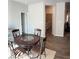 Open dining area shows wood floors, round table and view to the laundry and living room at 457 Panhandle Pl, Hampton, GA 30228