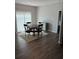 Bright dining area featuring wood floors, neutral walls, and a round table with seating for four at 457 Panhandle Pl, Hampton, GA 30228