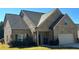 Charming single-Gathering home with a brick facade, manicured lawn, and a two-car attached garage at 457 Panhandle Pl, Hampton, GA 30228