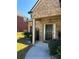 Charming brick home with a covered front entrance and manicured landscaping at 457 Panhandle Pl, Hampton, GA 30228