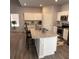 Spacious open kitchen features granite countertops, white cabinetry and stainless steel appliances at 457 Panhandle Pl, Hampton, GA 30228
