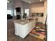 Open concept kitchen with granite countertops, stainless steel appliances, and white cabinets at 457 Panhandle Pl, Hampton, GA 30228