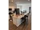 Bright kitchen features an island with bar seating, granite countertops, and stainless steel appliances at 457 Panhandle Pl, Hampton, GA 30228