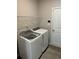 Laundry room featuring washer, dryer, wire shelving and convenient access door at 457 Panhandle Pl, Hampton, GA 30228