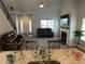 The open-concept living room features high ceilings, a fireplace, and comfortable leather sofas at 457 Panhandle Pl, Hampton, GA 30228