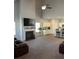Open concept living room featuring a fireplace, high ceilings, and a seamless transition to the kitchen at 457 Panhandle Pl, Hampton, GA 30228