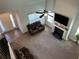 Bright living room with high ceilings, fireplace, fan, plush carpet, and abundant natural light at 457 Panhandle Pl, Hampton, GA 30228