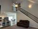 Open floor plan features a staircase and a living area with high ceilings and comfortable seating at 457 Panhandle Pl, Hampton, GA 30228
