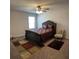Carpeted main bedroom featuring ceiling fan, and ornate dark wood bedroom set at 457 Panhandle Pl, Hampton, GA 30228