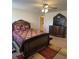 Spacious main bedroom featuring ceiling fan and a dark wood bedroom set at 457 Panhandle Pl, Hampton, GA 30228