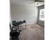 Bright, carpeted office space with ceiling fan, window, and desk setup at 457 Panhandle Pl, Hampton, GA 30228