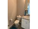 Compact powder room offers a stylish sink vanity, toilet, and modern fixtures at 457 Panhandle Pl, Hampton, GA 30228