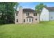 Well-maintained backyard showcasing the home's rear exterior and spacious grassy area at 237 River Pass Ct, Dacula, GA 30019