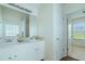 This bathroom has double sinks, white cabinets, and a mirror at 237 River Pass Ct, Dacula, GA 30019