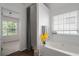 Bright bathroom featuring a tub, shower and a window for natural light at 237 River Pass Ct, Dacula, GA 30019