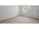 This large bedroom features a window and neutral carpeting at 237 River Pass Ct, Dacula, GA 30019