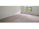 Spacious bedroom with neutral walls and plush carpeting, complemented by a window at 237 River Pass Ct, Dacula, GA 30019