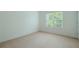 Bright bedroom featuring neutral carpet, window, and white walls at 237 River Pass Ct, Dacula, GA 30019
