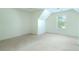 Bedroom with neutral carpet, tray ceiling, and window overlooking the yard at 237 River Pass Ct, Dacula, GA 30019
