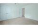 This bedroom features double doors, light walls and carpet, and ample natural light at 237 River Pass Ct, Dacula, GA 30019